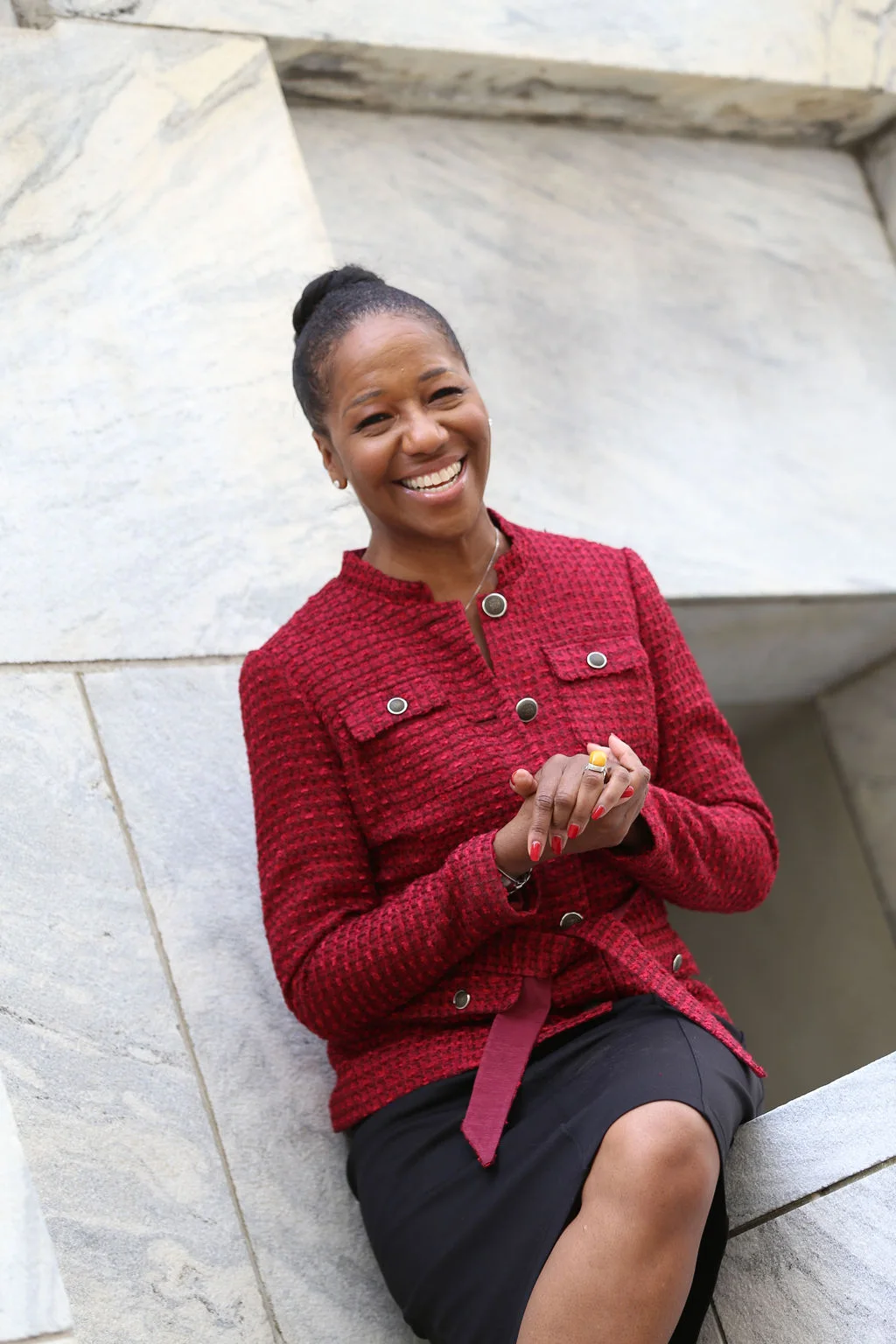 Teri Lee Thompson outside a civic building in a red jacket
