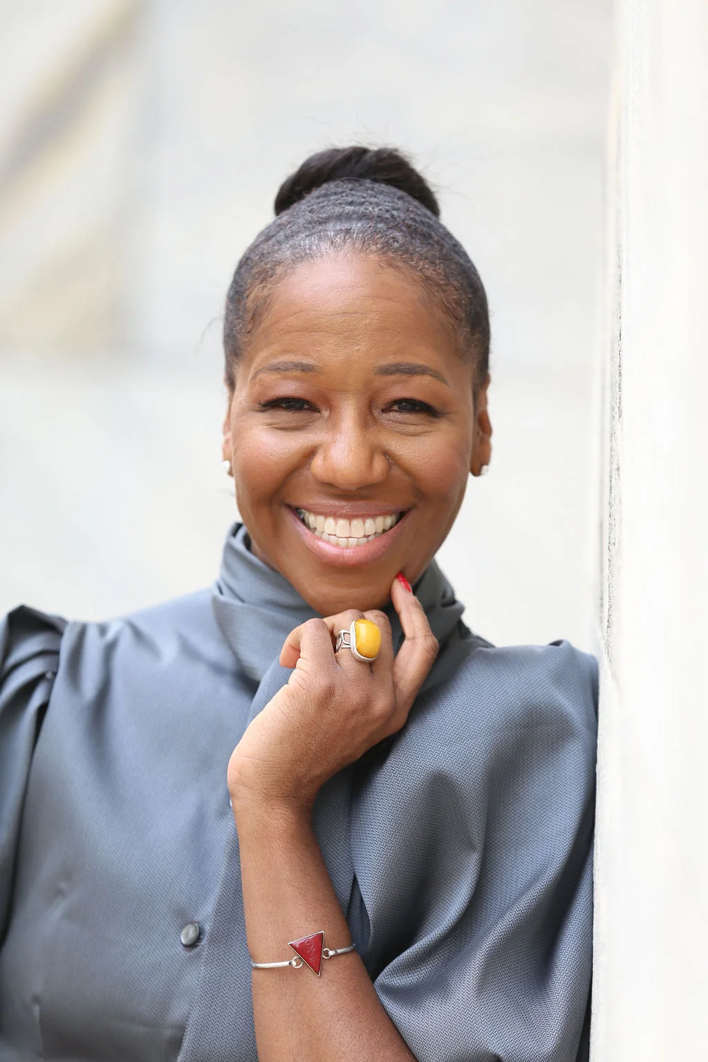 Teri Lee Thompson smiling in a gray suit